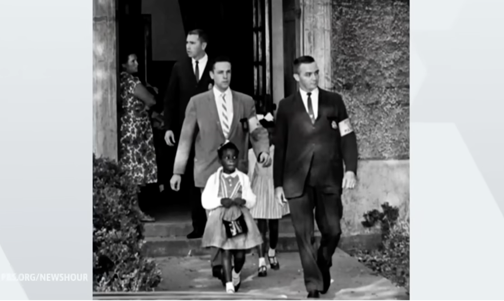 Credit: PBS News Hour screenshot of Leona Tate, civil rights activist, when she was 6-years-old and had enrolled in what had been an all-white school in New Orleans. She and several other young Black students became the first to desegregate a New Orleans school.