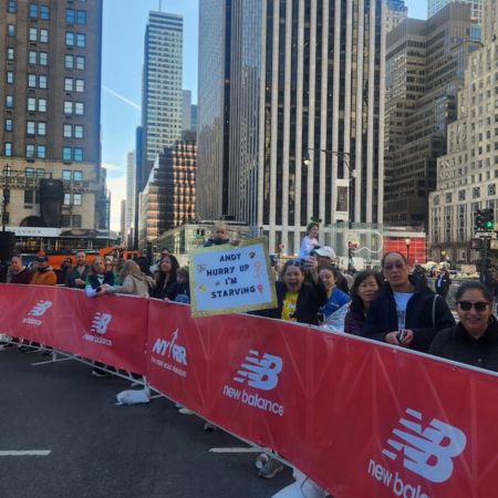 Sissy cheering me on near the finish line of the NYC Half Marathon shortly before giving birth to Rosa.Sikgn Sign reads: Andy hurry up I'm hungry!